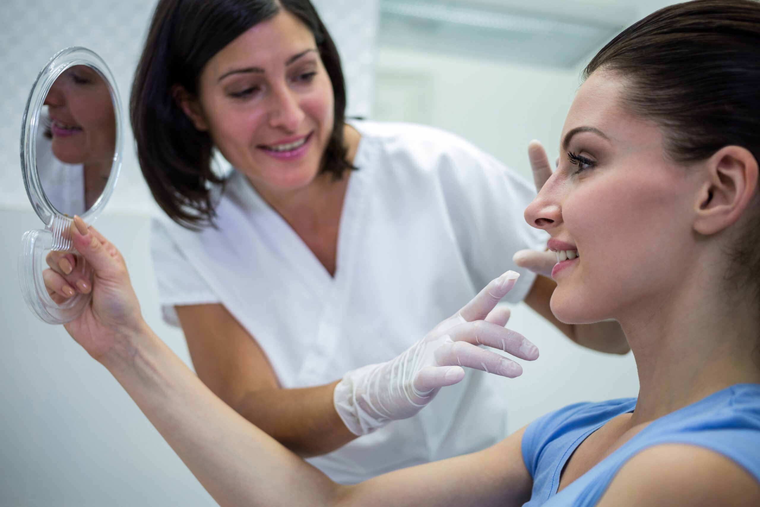 Doctor examining patients face at clinic